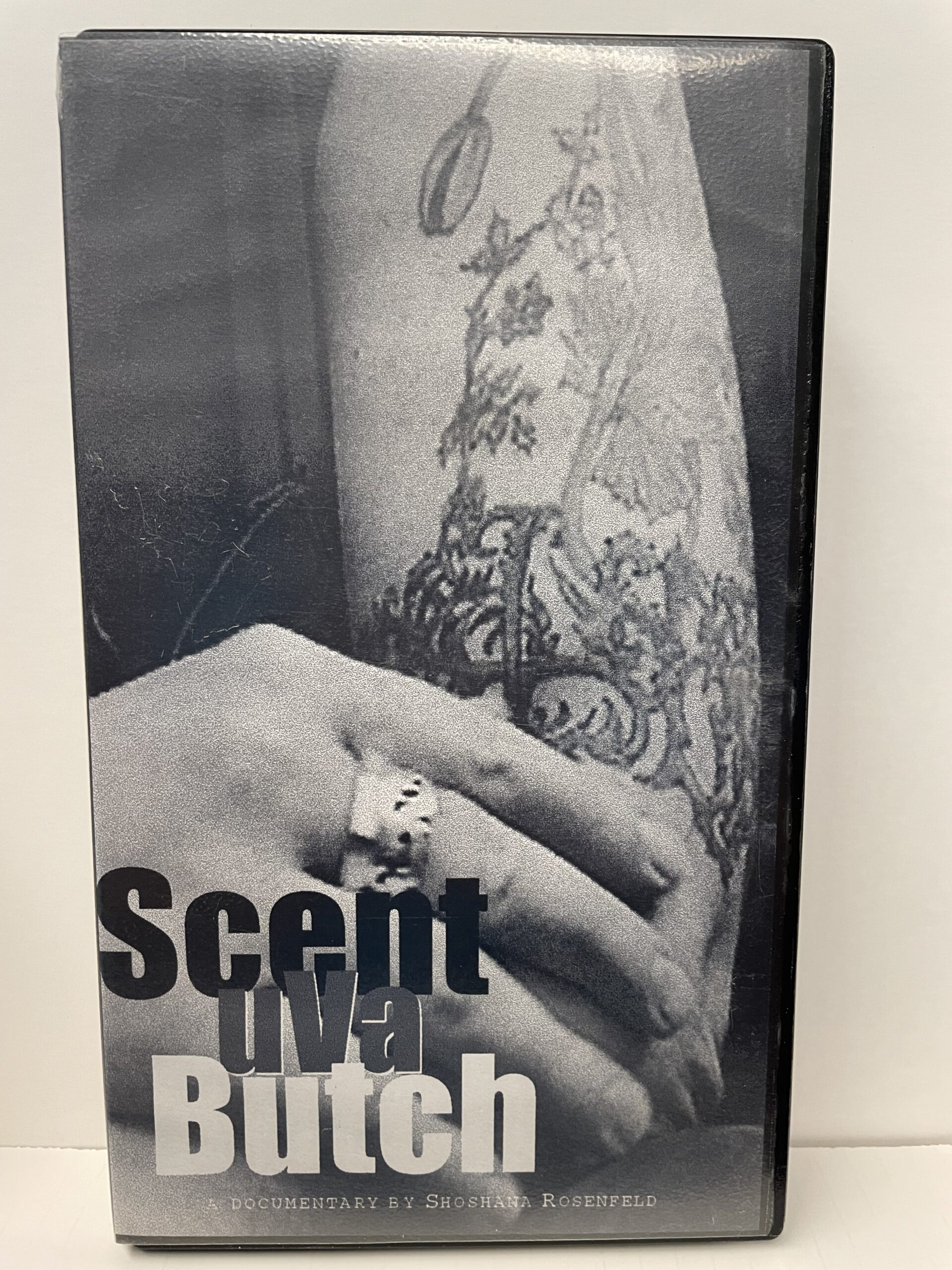 A physical VHS cover featuring a tattooed forearm that reads Scent uVa Butch, a documentary.